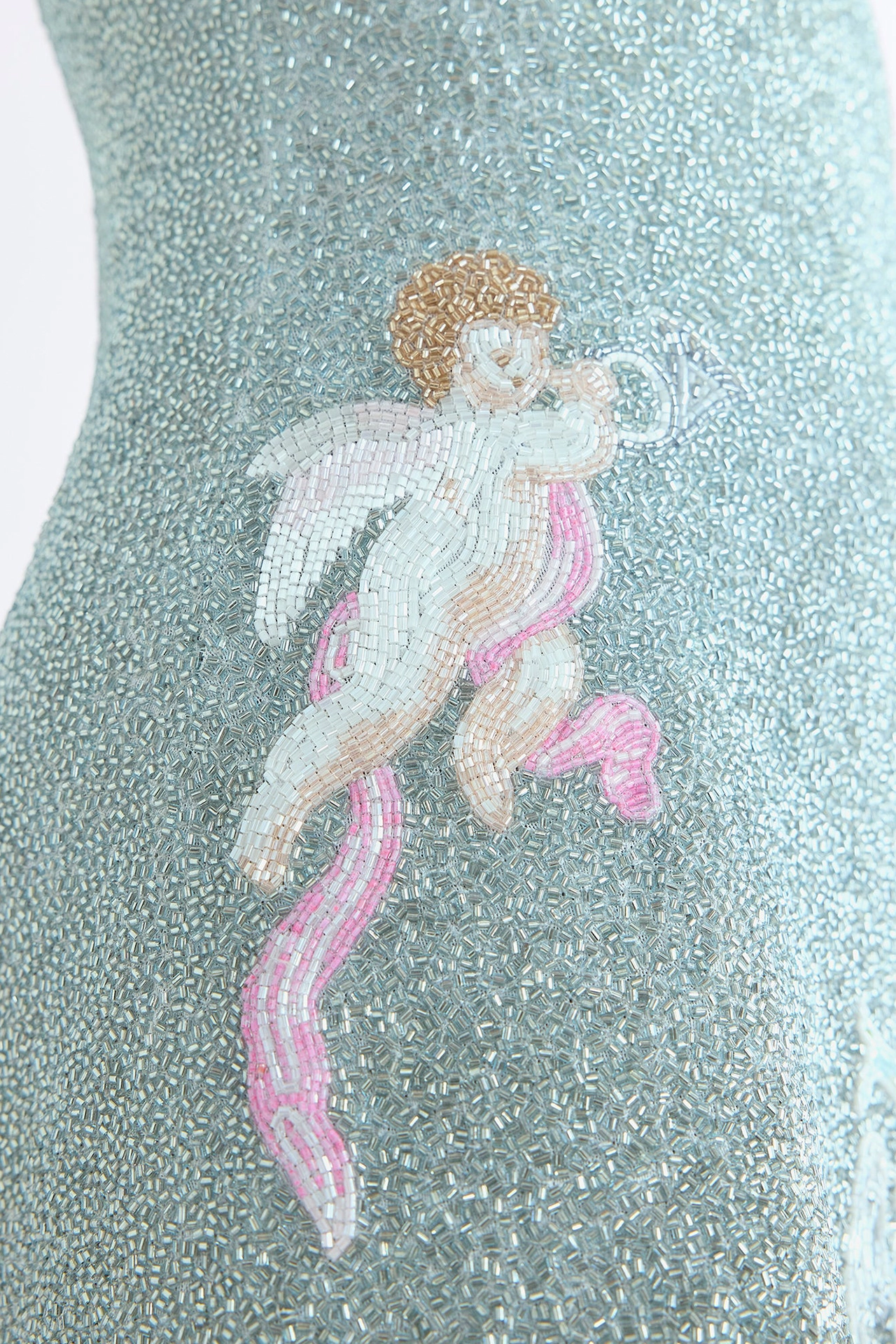 Close-up of gold and silver hand-embellished renaissance motifs on luxury beaded party mini dress