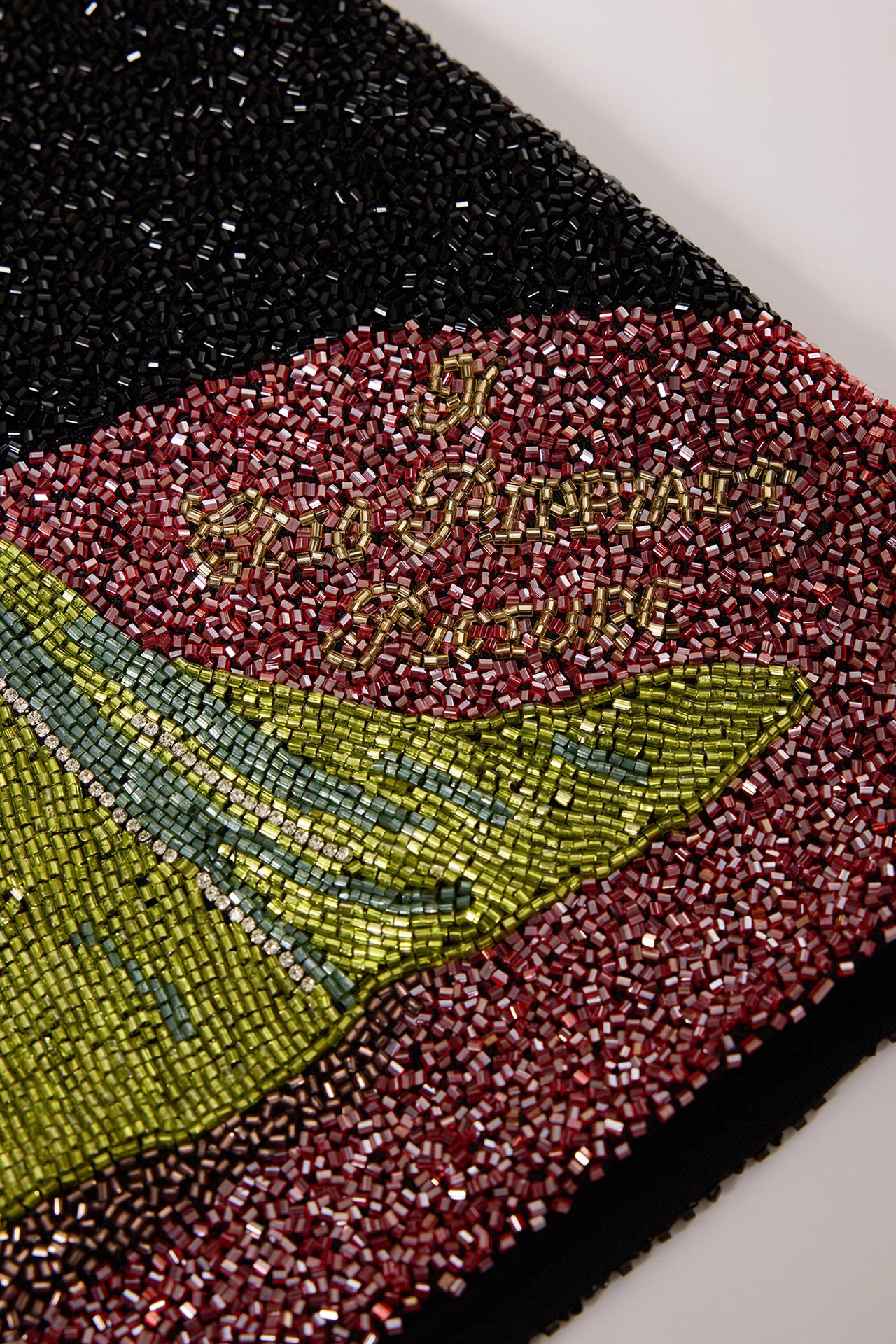 Close-up of hand-made glass beads on a black short dress with beads