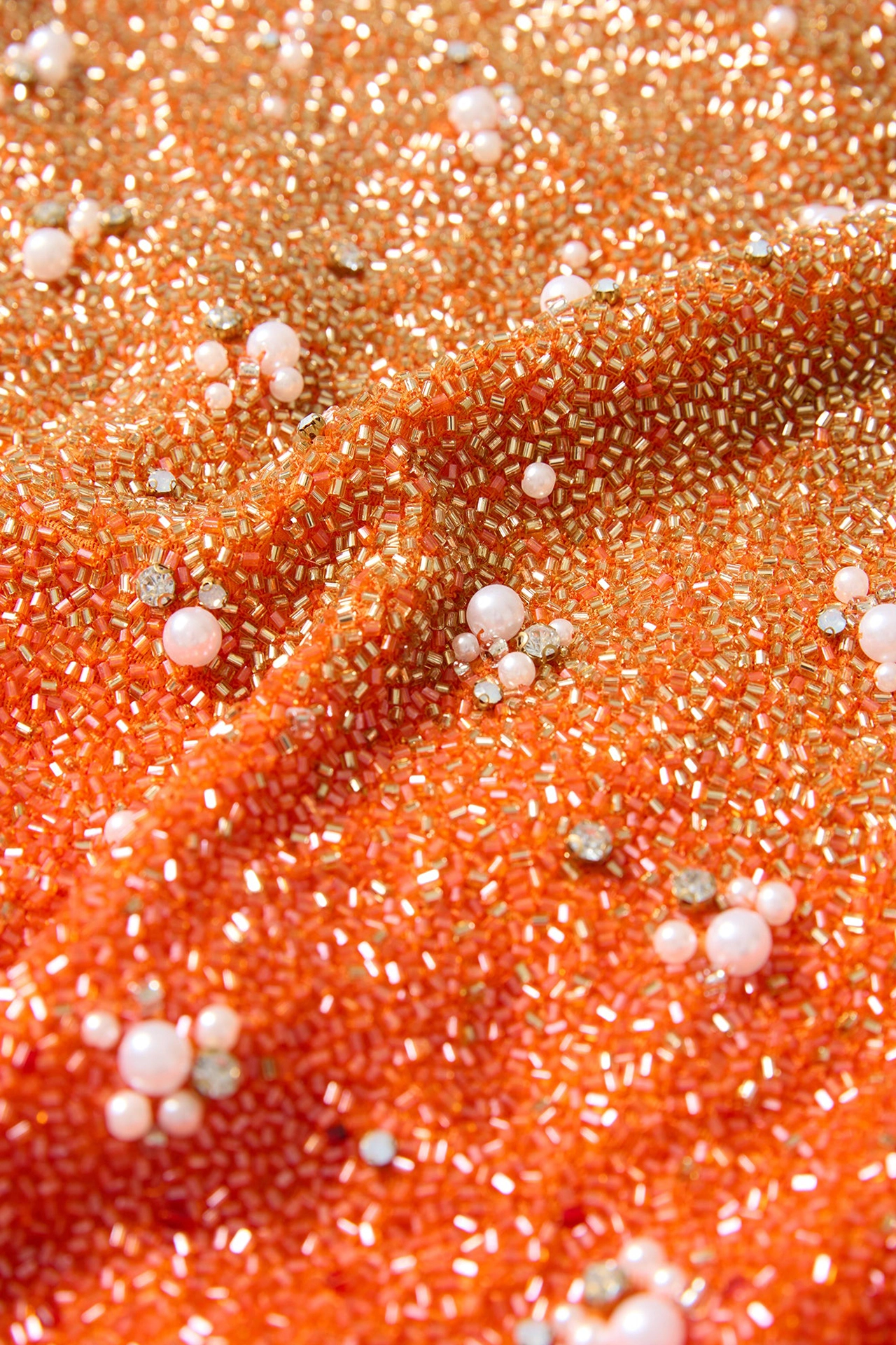 Extreme close-up of hand-sewn metallic seed beads and pearls from Gradient Mini Phoenix