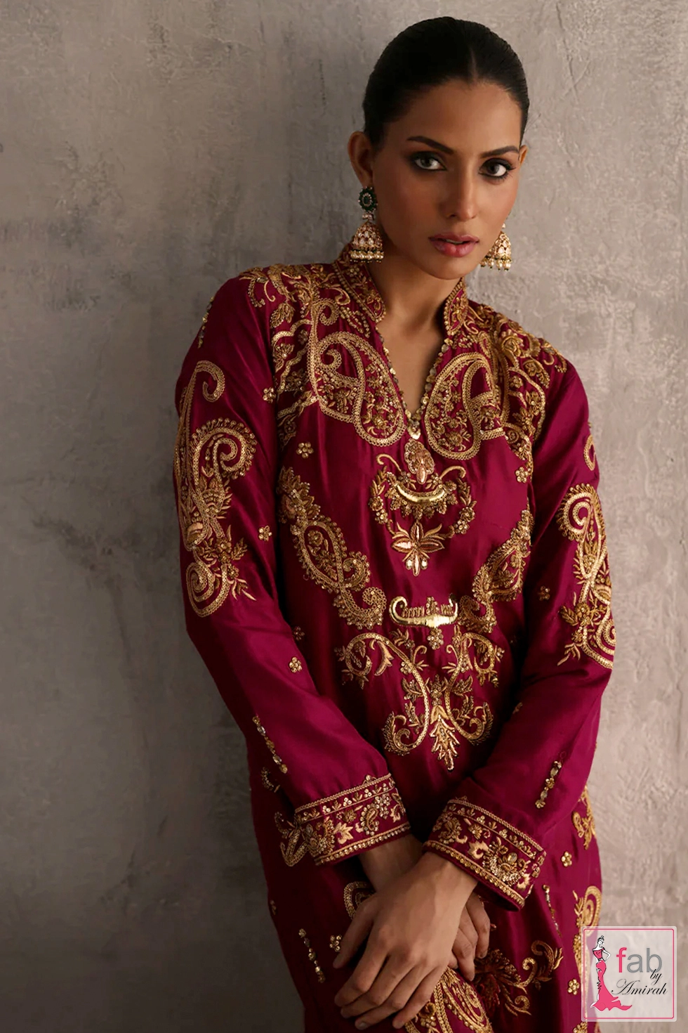 Close-up of traditional marori embroidery on premium long fuchsia raw silk shirt
