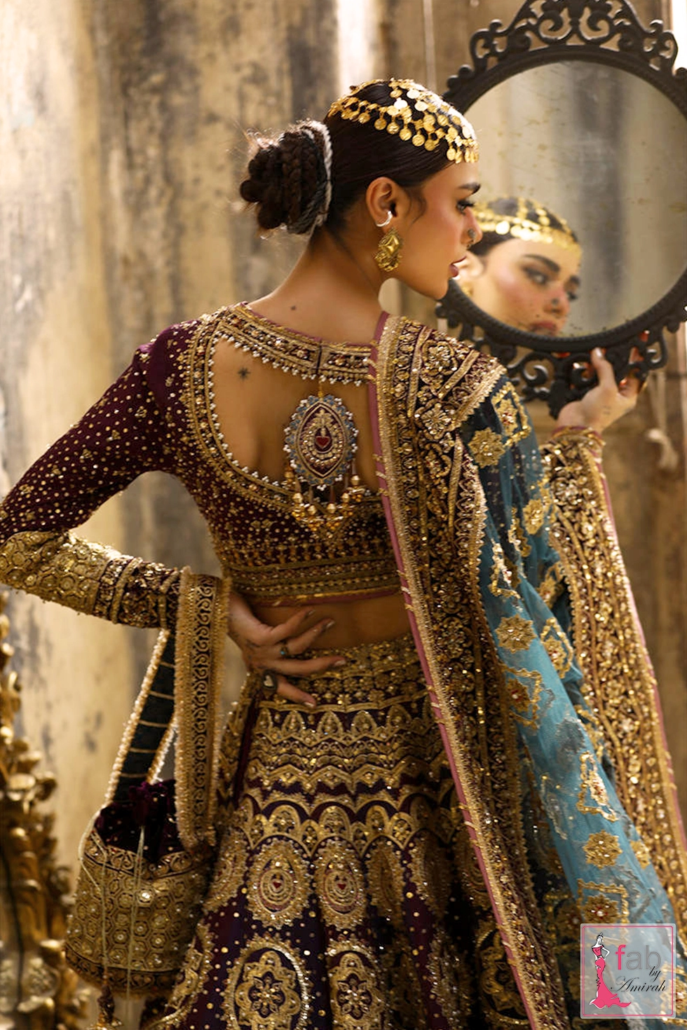Back profile of embroidered choli showing heavy adda work