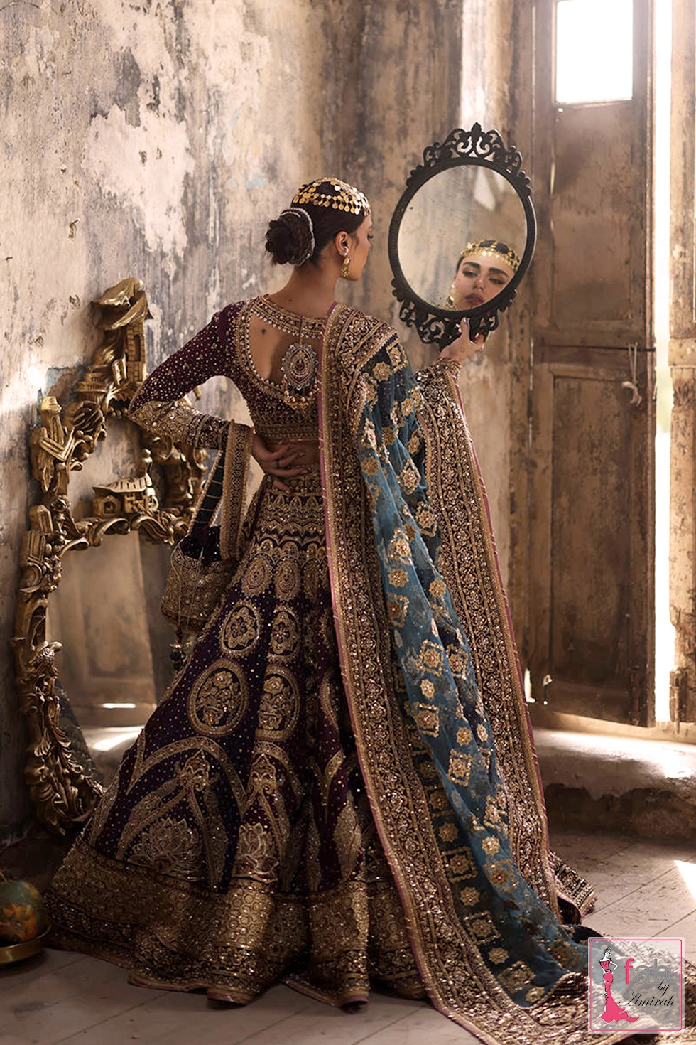 Back profile of embroidered choli showing heavy adda work