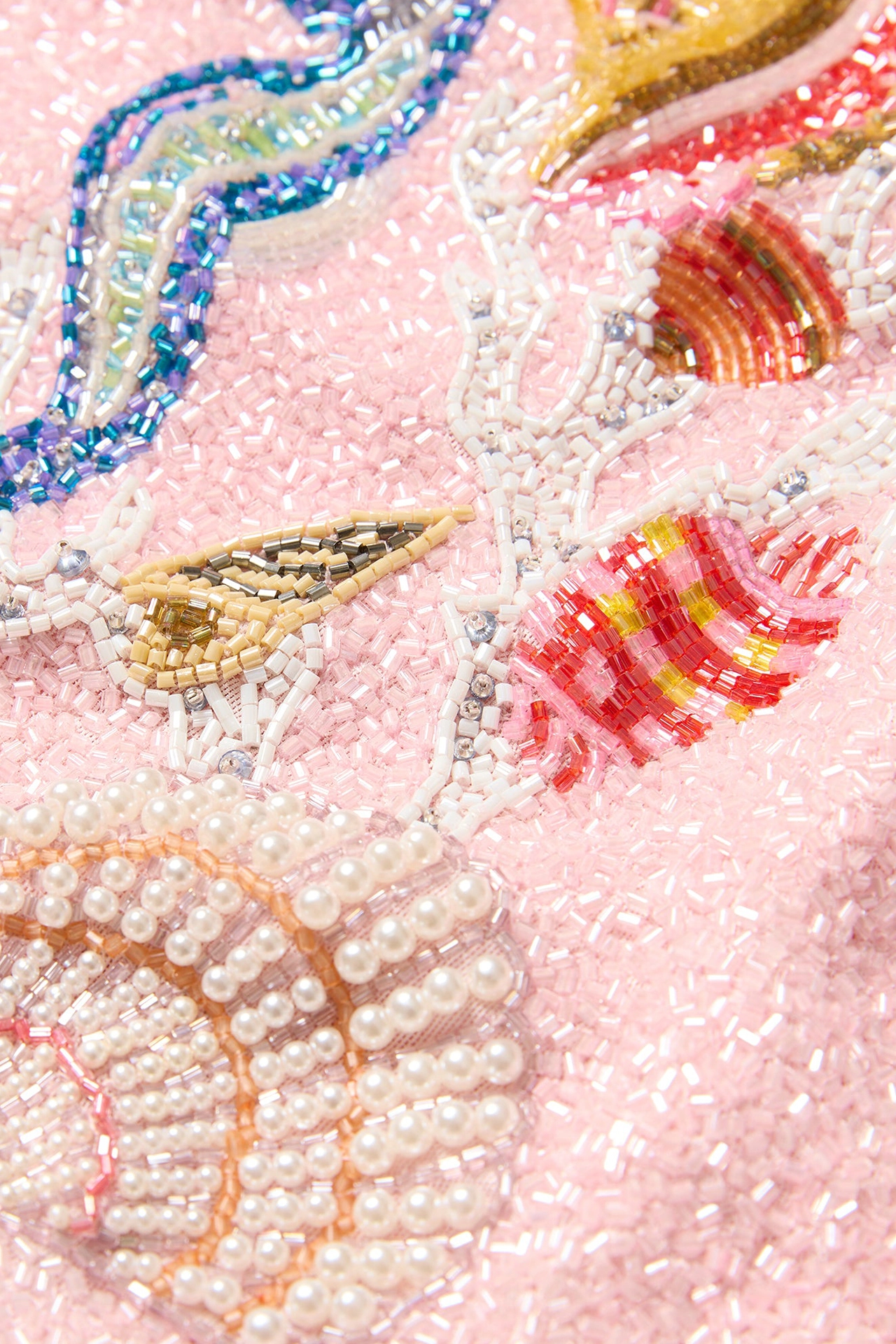 Close-up of glass beads and sea shell embellished cocktail dress details