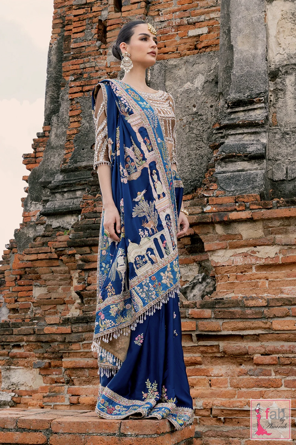 Model wearing royal blue wedding saree ensemble by Fab By Amirah