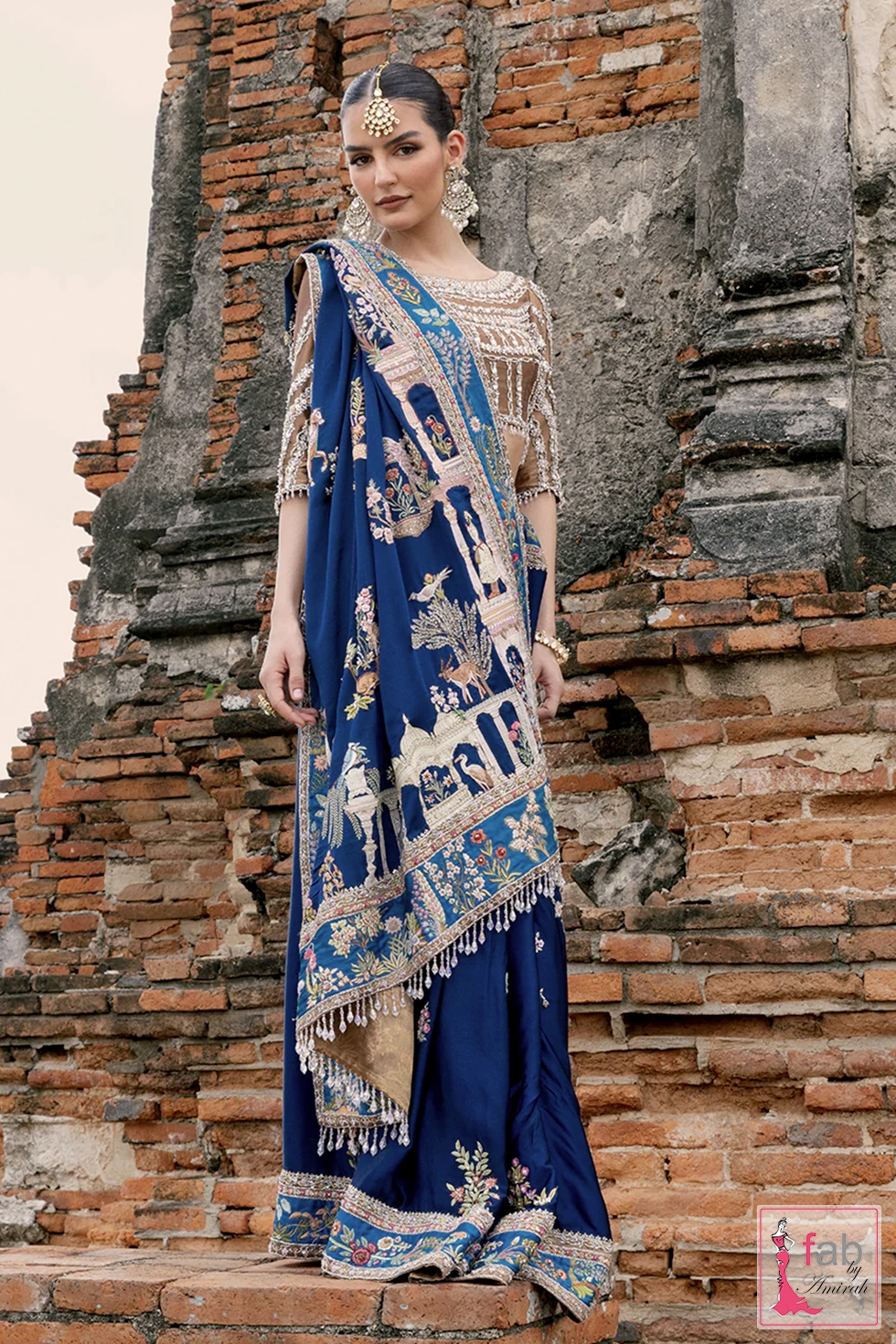 Close-up of resham thread work embroidery on royal blue silk blouse