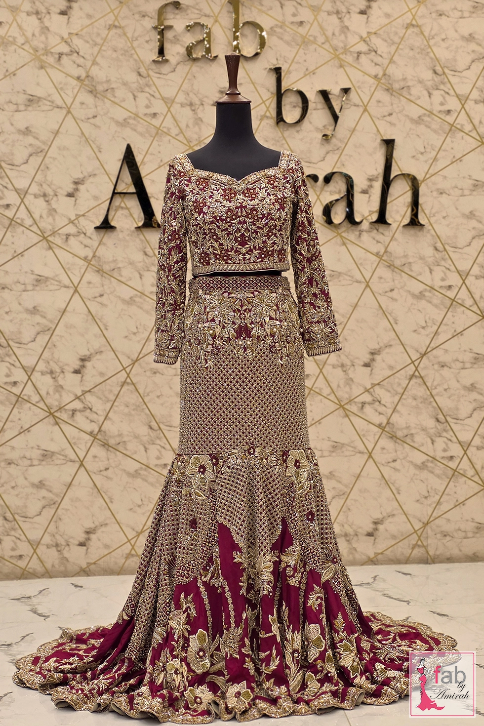 Close-up of intricate hand-stitched gold zardozi on deep plum choli