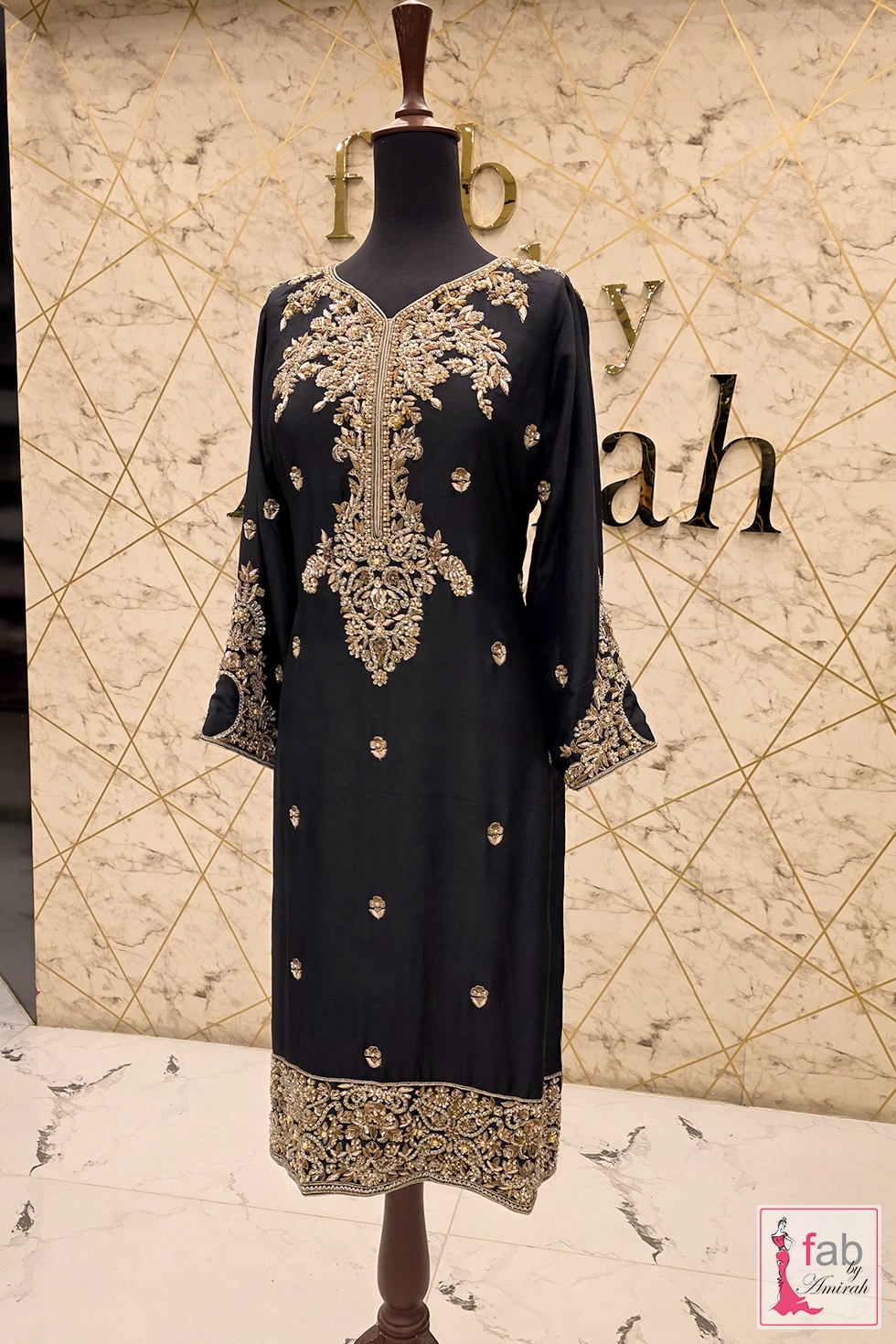 Intricate gold tilla scrollwork borders on full-length formal shirt sleeves Intricate gold tilla scrollwork borders on full-length formal shirt sleeves