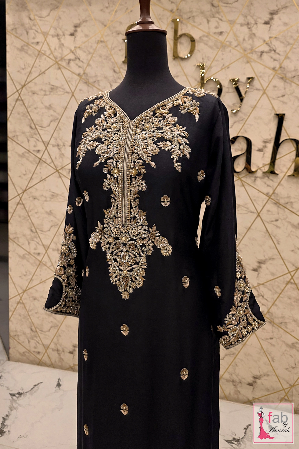Complete black raw silk embroidered formal outfit showcasing heavy geometric border designs Complete black raw silk embroidered formal outfit showcasing heavy geometric border designs