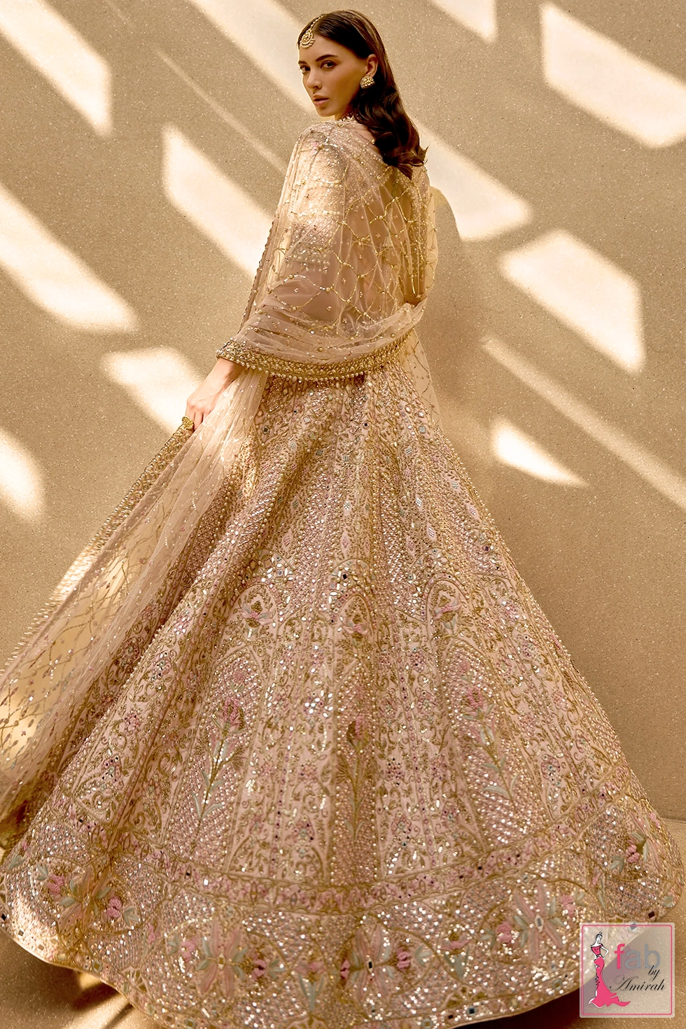 Full length back view showing the flared raw silk lehenga skirt and decorated border Full length back view showing the flared raw silk lehenga skirt and decorated border