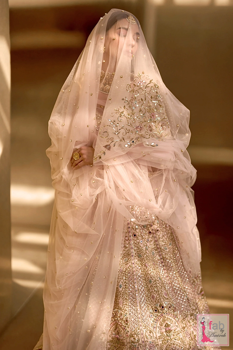 Close up view of sheer net veil draped over model with pearl and sequin embroidery Close up view of sheer net veil draped over model with pearl and sequin embroidery