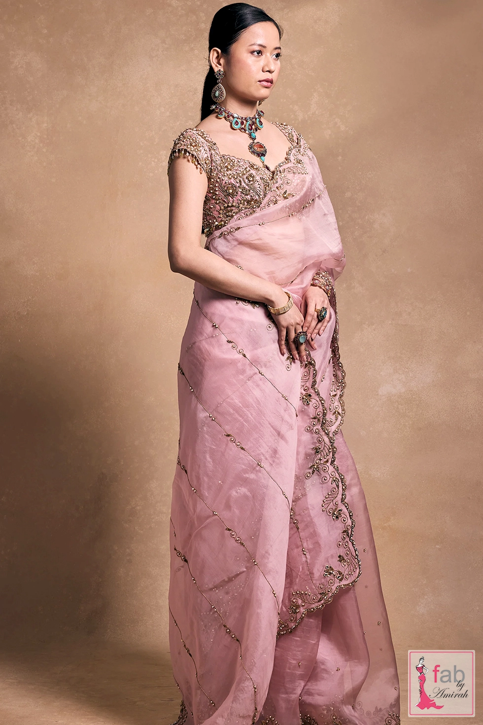 Side angle view showcasing sheer organza saree drape and hand embellished blouse. Side angle view showcasing sheer organza saree drape and hand embellished blouse.
