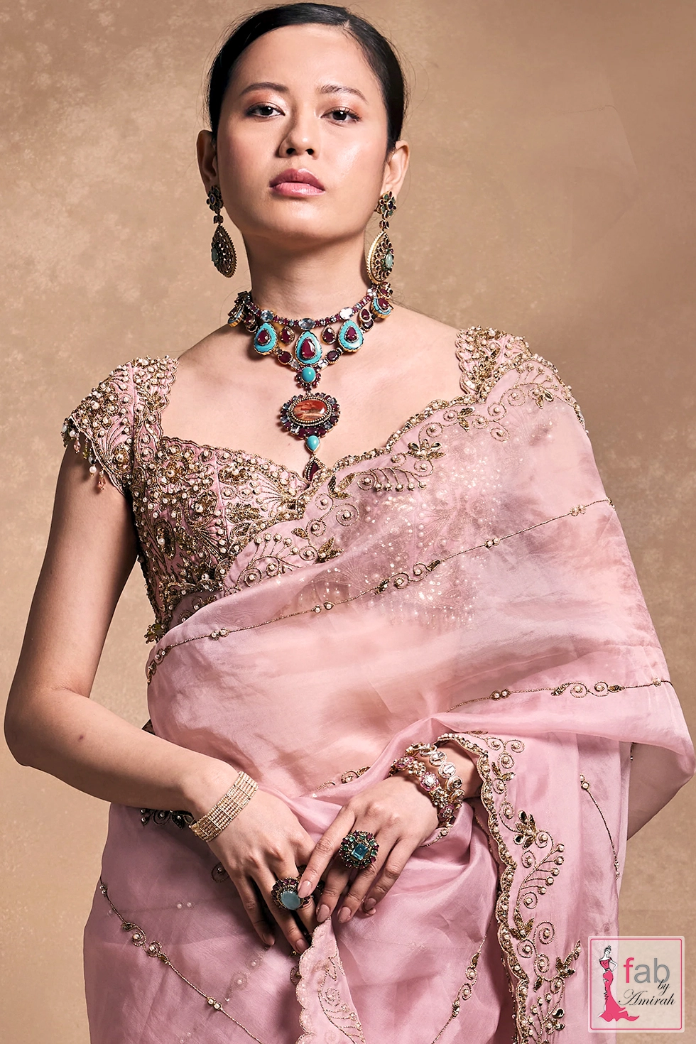 Close up view of designer pink organza saree showing blouse embroidery. Close up view of designer pink organza saree showing blouse embroidery.