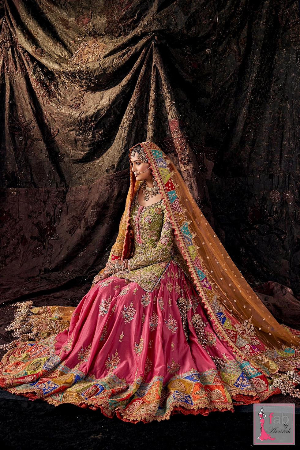 Side profile showing the embroidered dupatta border and multi-hued lehenga flare