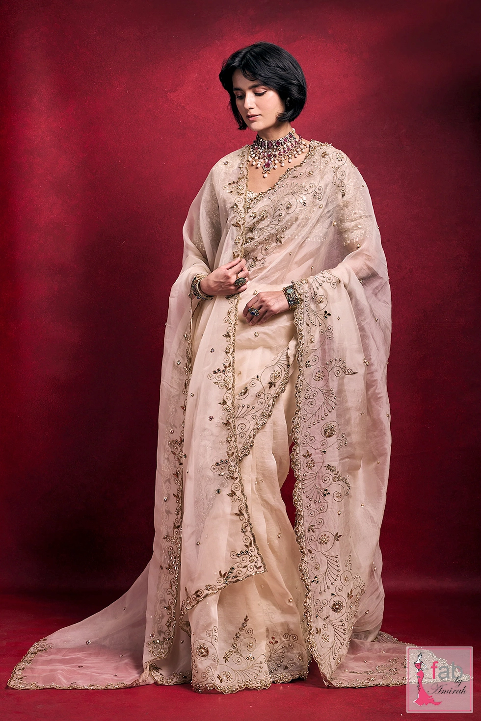 Full length drape view of cream organza embroidered saree Full length drape view of cream organza embroidered saree
