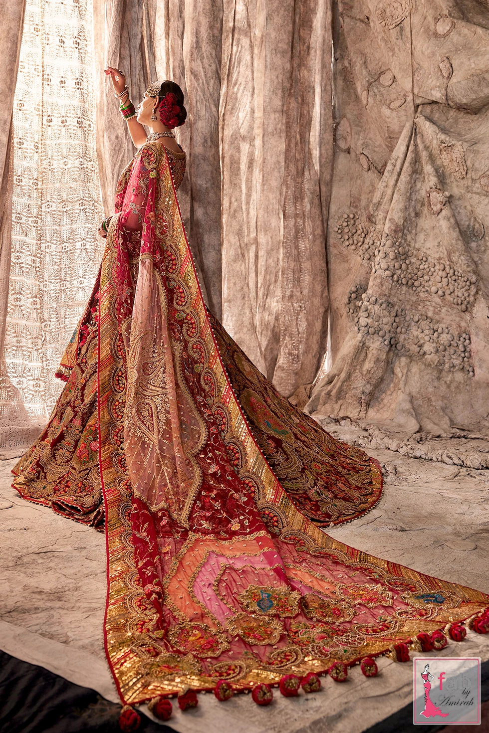 Full side profile of the deep maroon lehenga displaying the sweeping train.