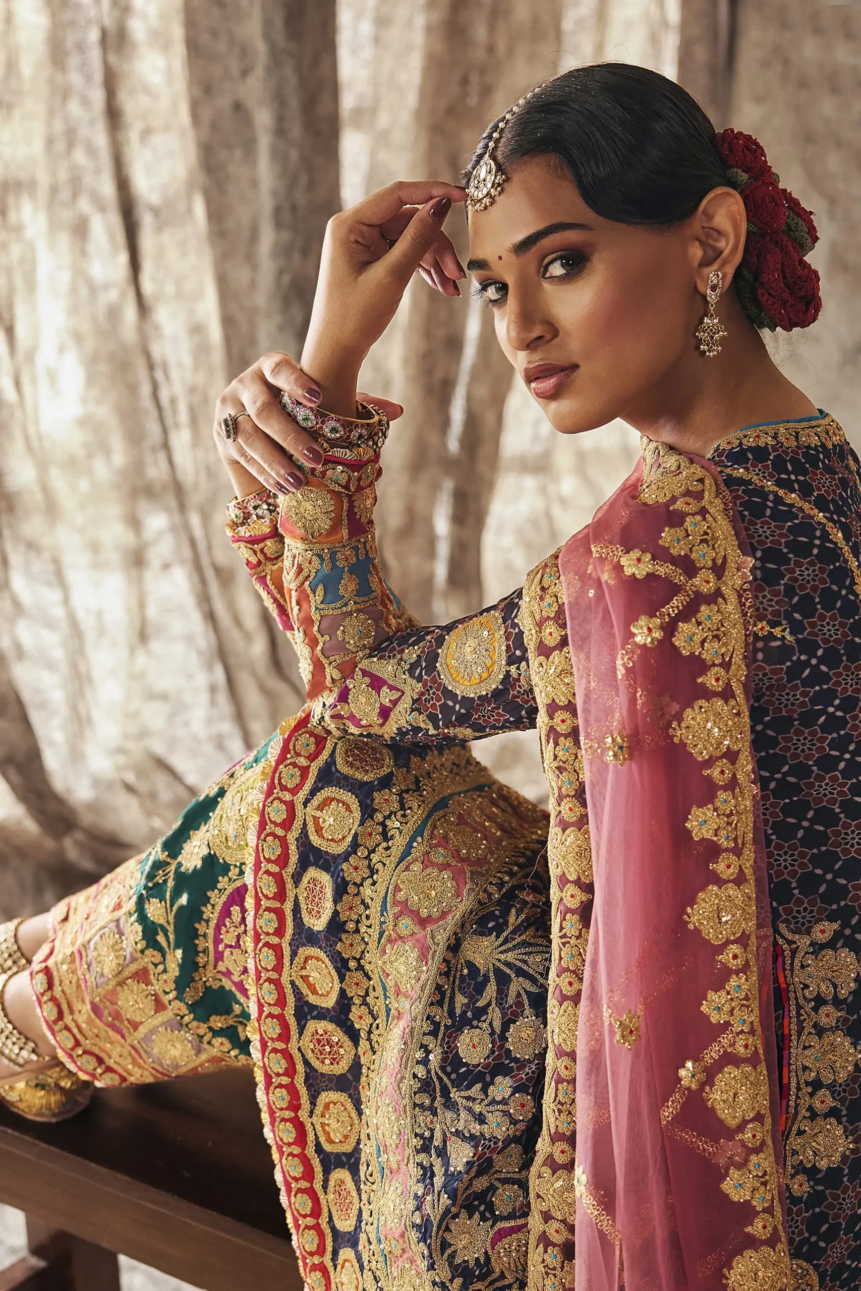 Designer party wear dress in lapis navy featuring close up of model with vintage rose dupatta and gold jewelry accents Designer party wear dress in lapis navy featuring close up of model with vintage rose dupatta and gold jewelry accents