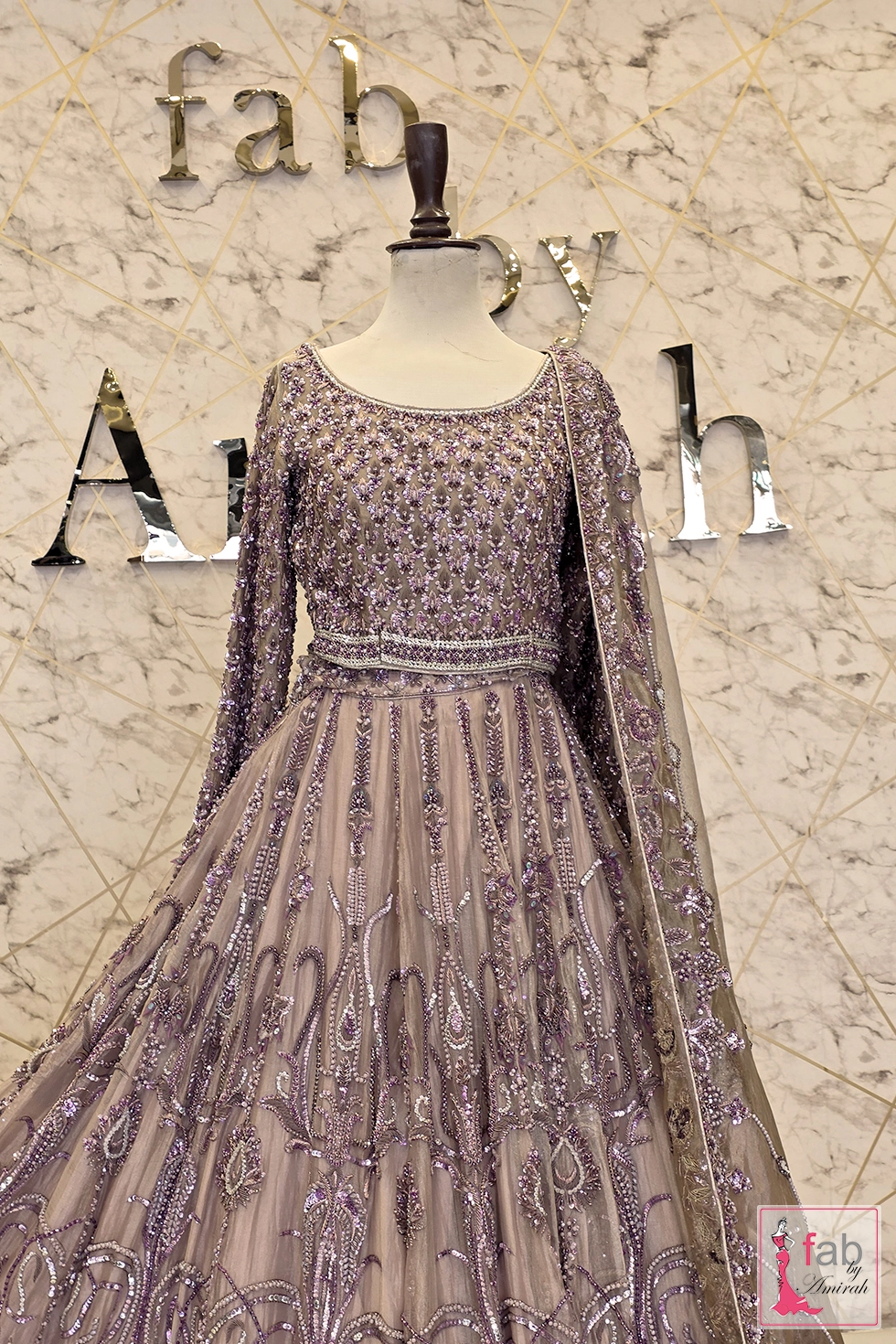 Full front view of mauve purple bridal lehenga set on mannequin