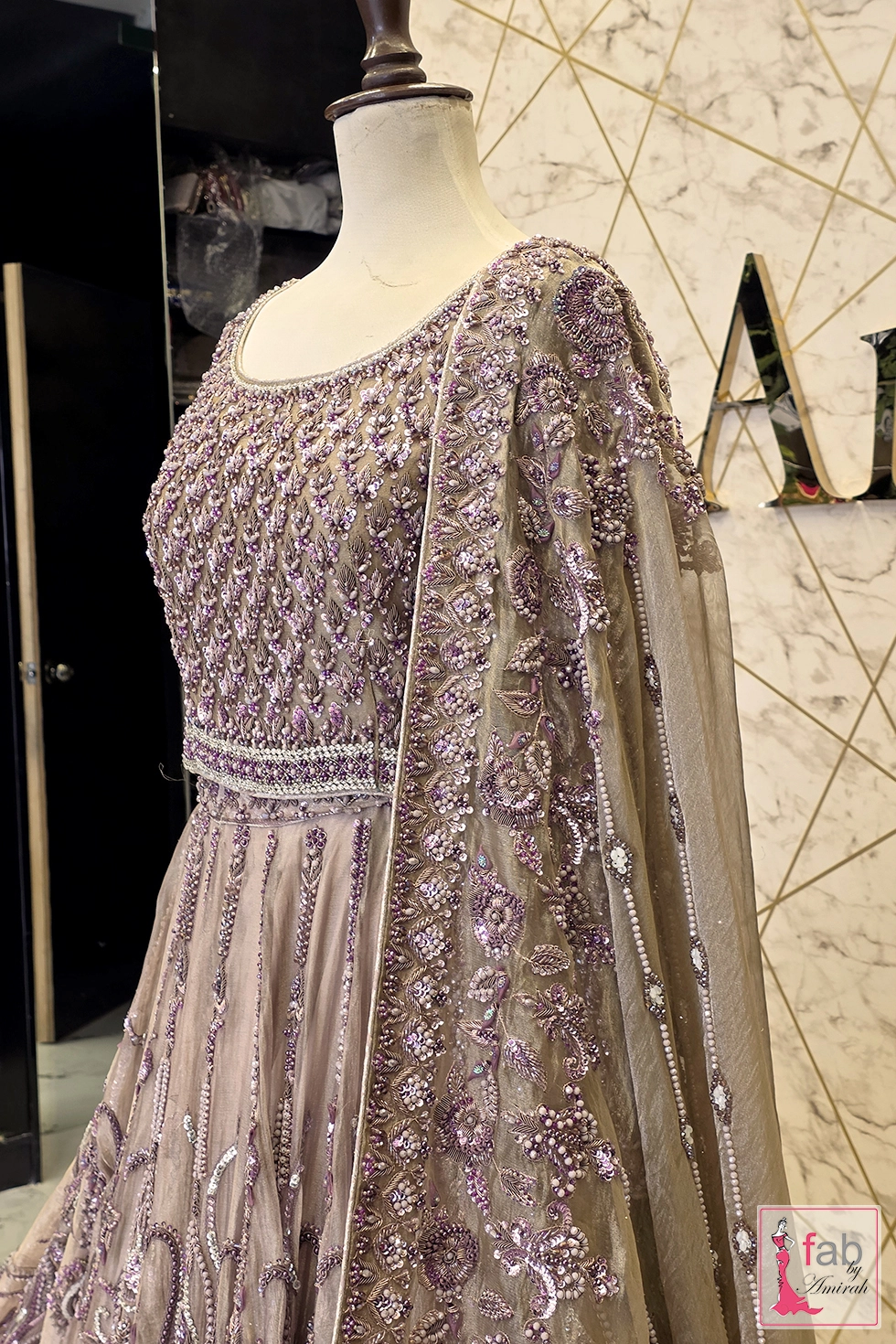 Side profile of embellished blouse and draped dupatta on mannequin