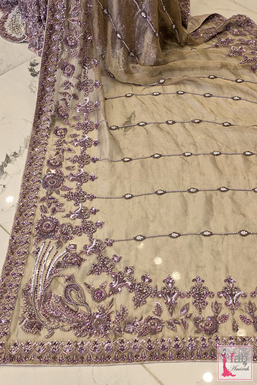 Close up of sheer dupatta border with purple sequins and pearl embellishments