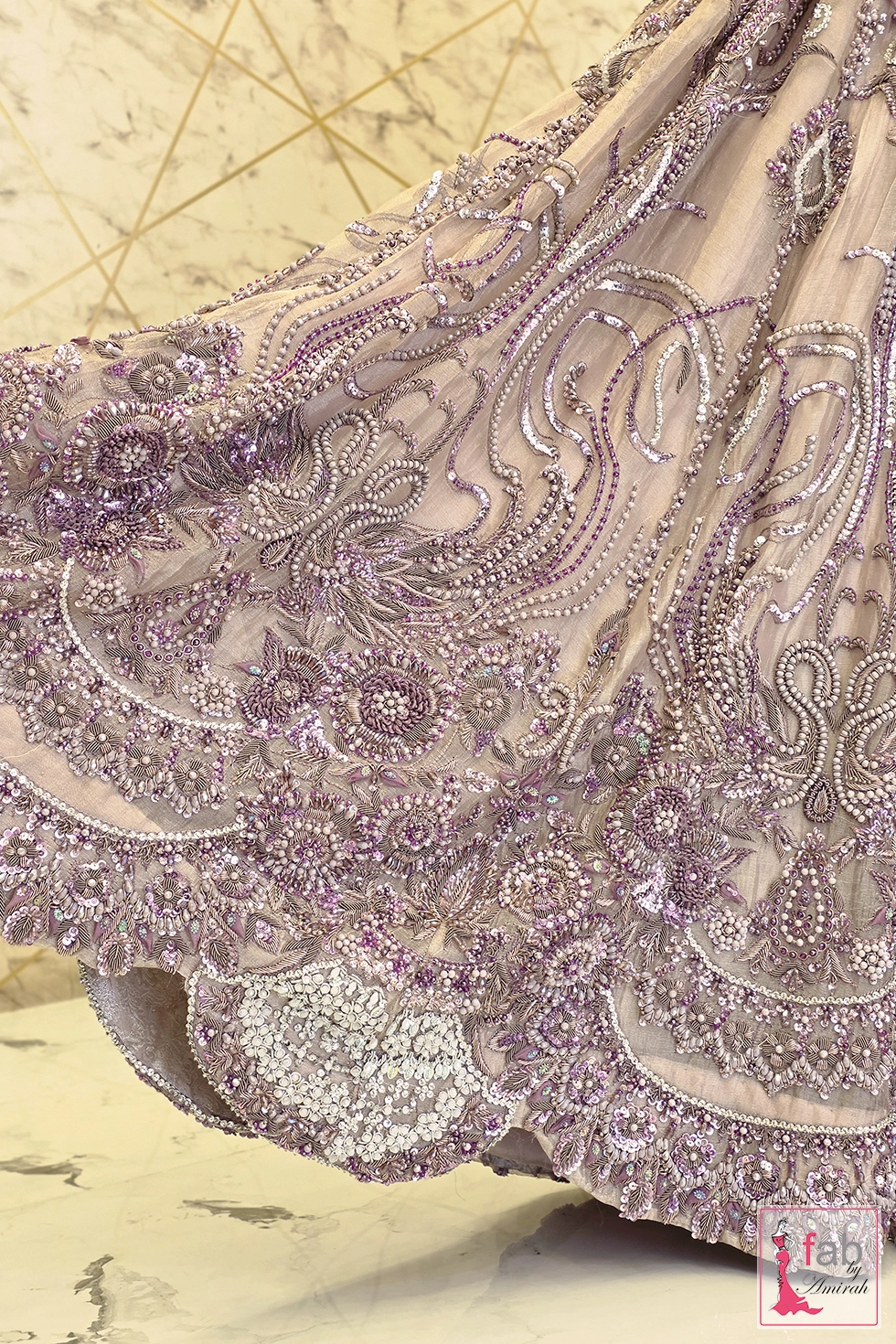 Hemline close up displaying scalloped border and cutdana work