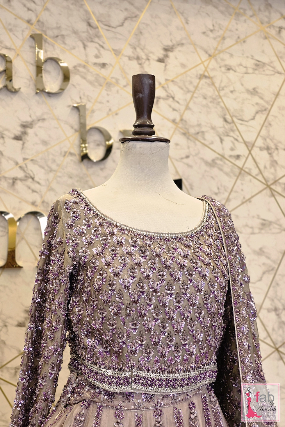 Upper bodice view showing round neckline and fitted long sleeves