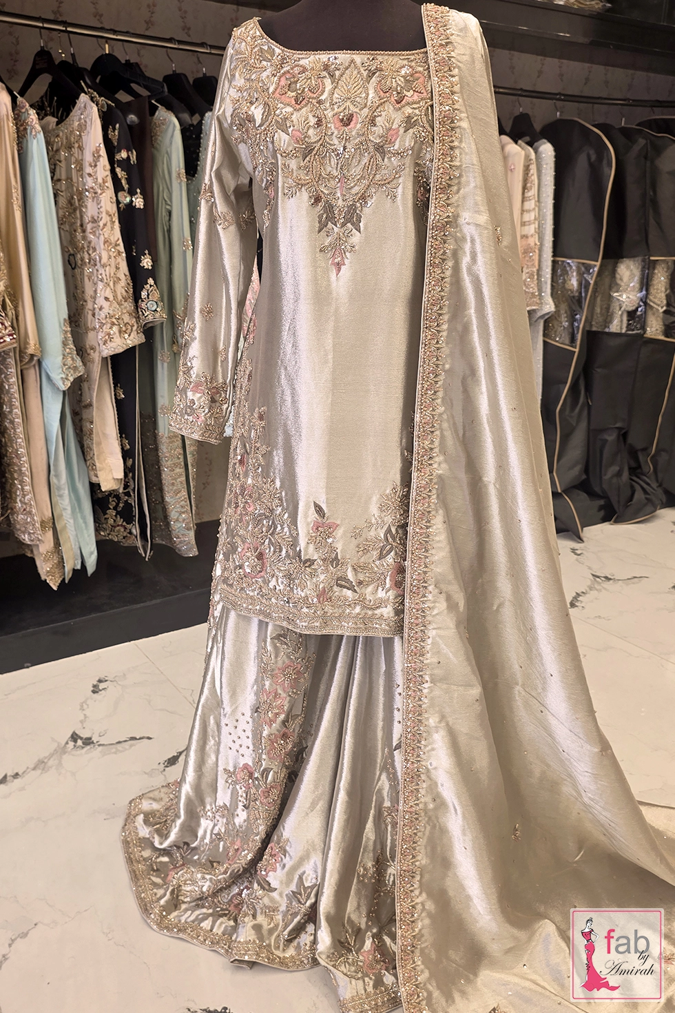 Silver Sharara Suit with detailed hand embroidery and matching dupatta on display