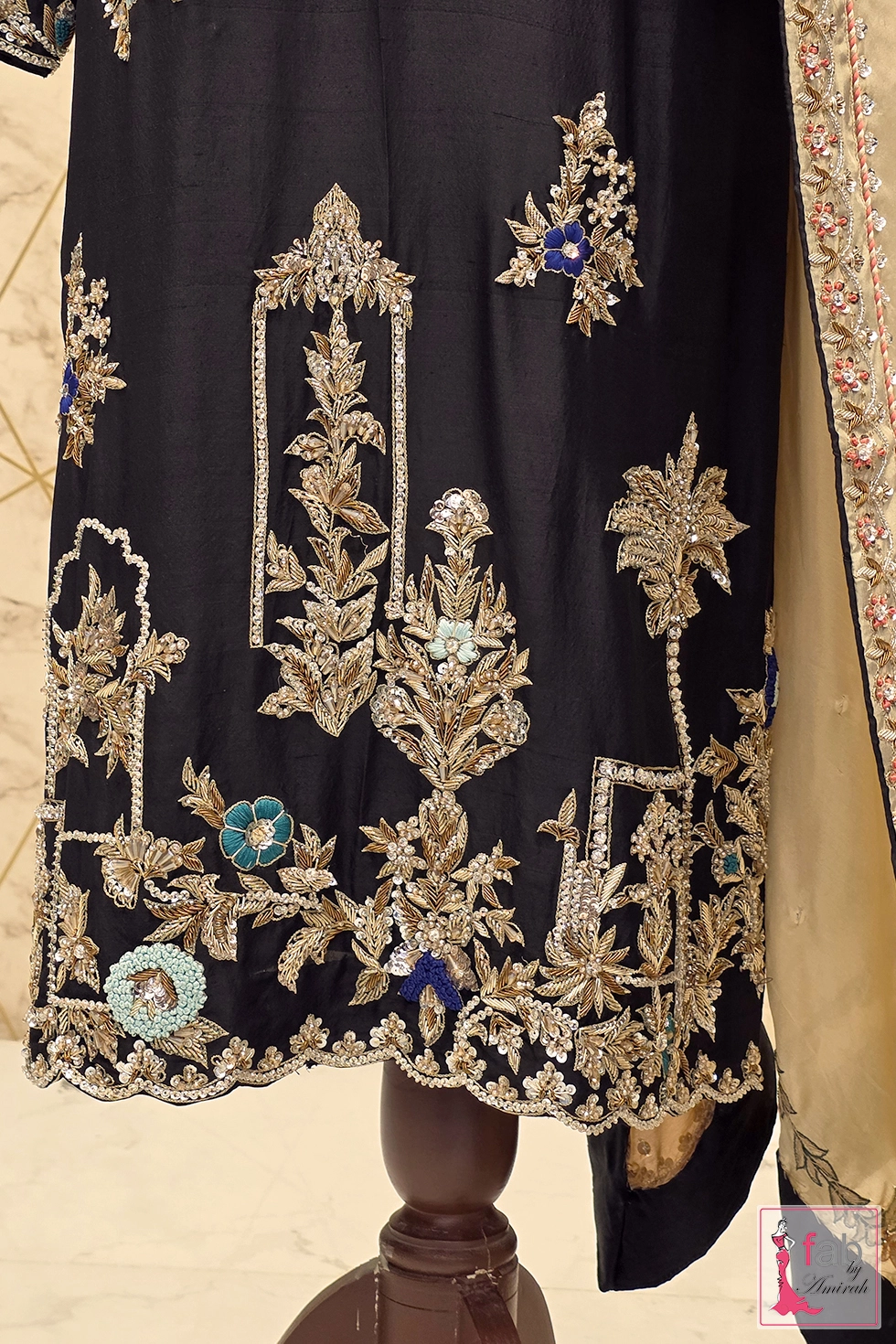 Lower hem detail of black silk straight shirt showing intricate zardozi embroidery Lower hem detail of black silk straight shirt showing intricate zardozi embroidery