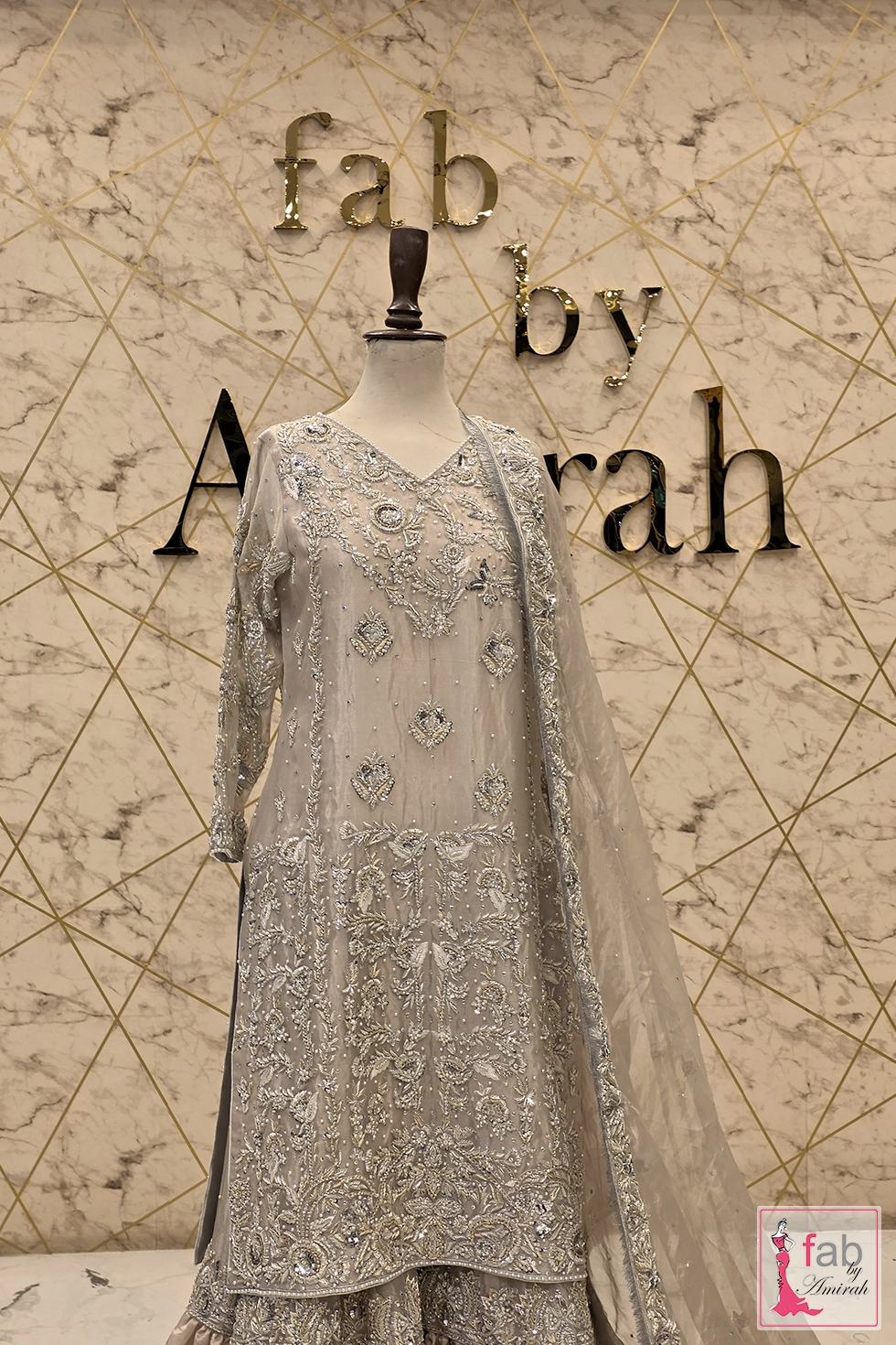 Full length straight camera angle of silver embroidered ensemble