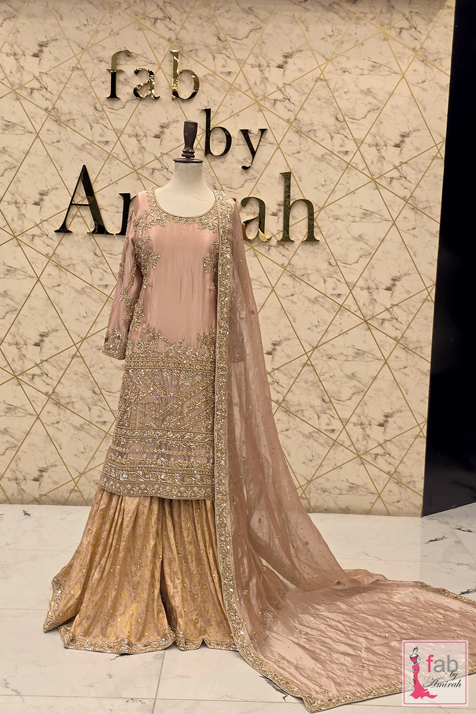 Full length front view showing the complete silhouette, two tiered sharara flare, and trailing net dupatta