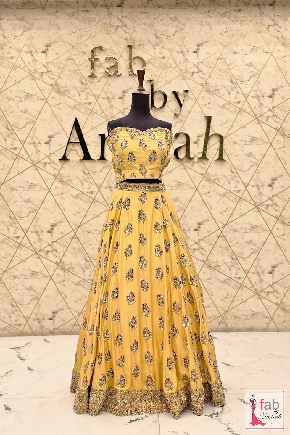 Front full length view of yellow hand embroidered lehenga choli