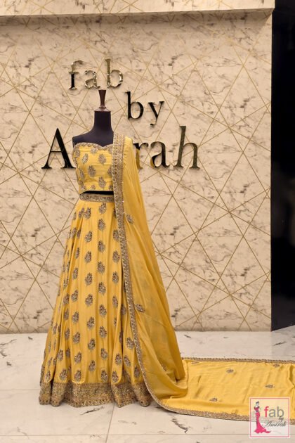FAB By AMIRAH 6 Bright yellow lehenga choli with heavy embellishment on mannequin