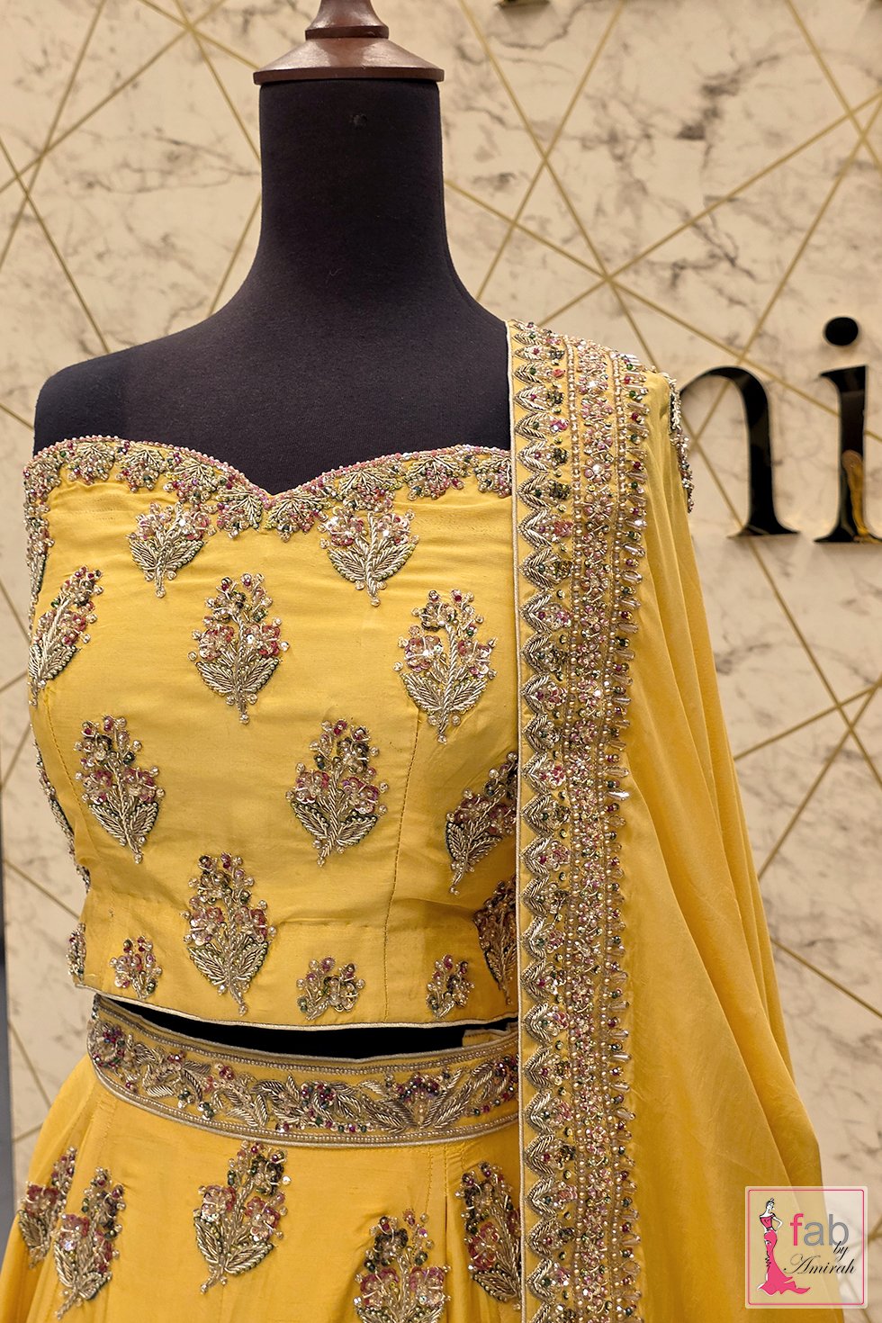 Close up of sweetheart blouse embroidery on yellow lehenga choli