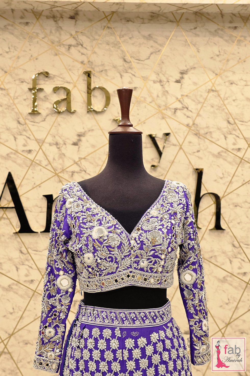 Front view of hand embroidered purple choli on mannequin display Front view of hand embroidered purple choli on mannequin display