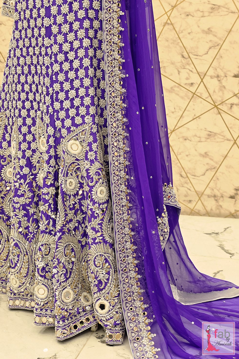 Detailed view of purple lehenga fabric panels and dupatta edge Detailed view of purple lehenga fabric panels and dupatta edge