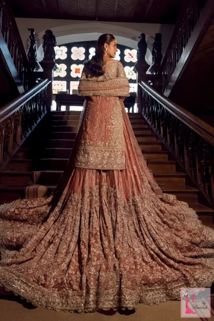 Back view of bride standing on grand wooden staircase