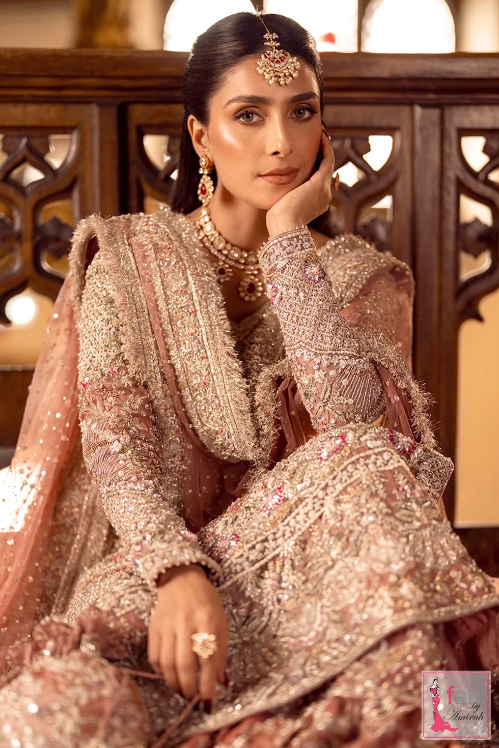 Close up view of hand embroidered sleeves and bridal jewelry