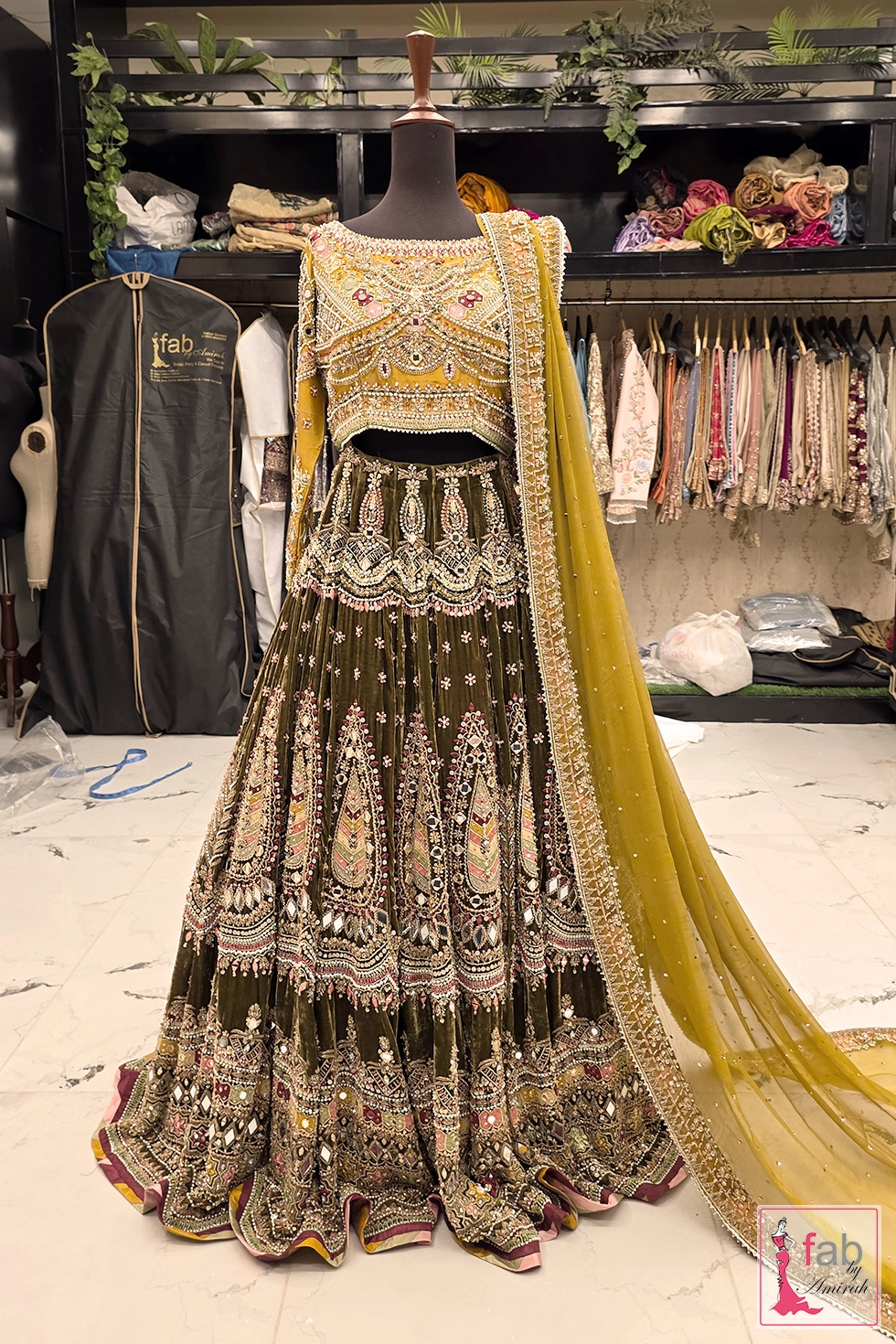 Front view of olive green velvet lehenga skirt and mustard choli