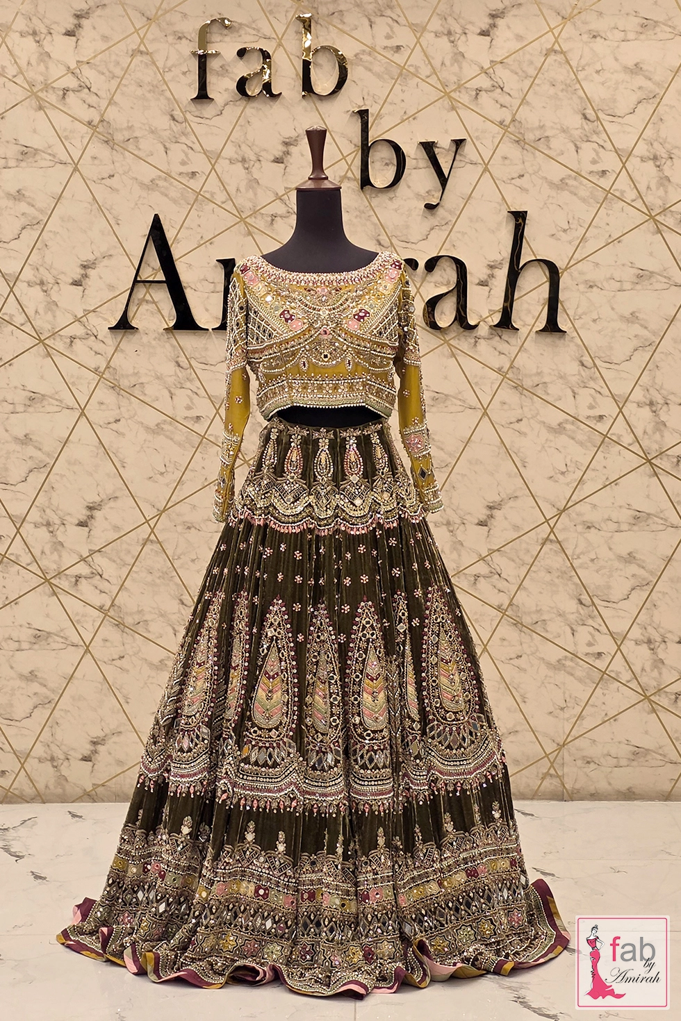 Olive green velvet lehenga displayed on full mannequin with dupatta draped