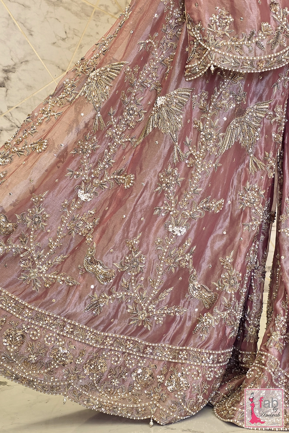 Detailed view of scalloped border craftsmanship on the sharara fabric