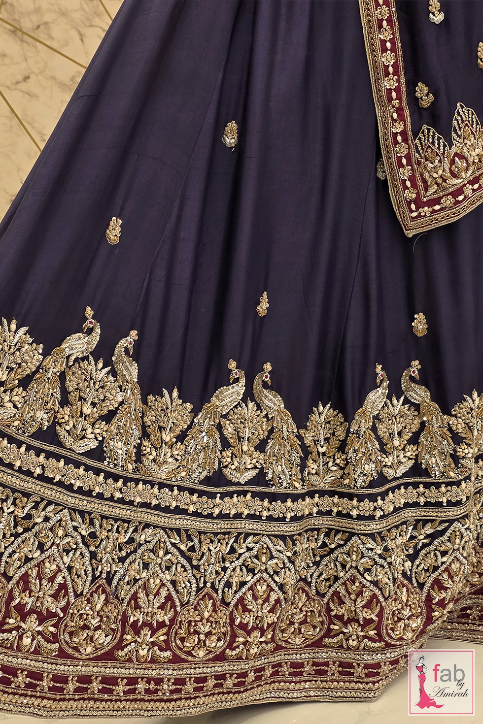 Close up of hand embroidered peacock motifs on the lehenga hem