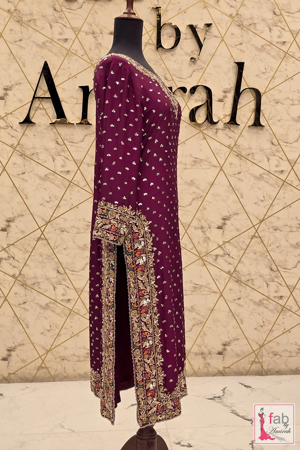 Side view showing embroidered shirt slit and side border detail