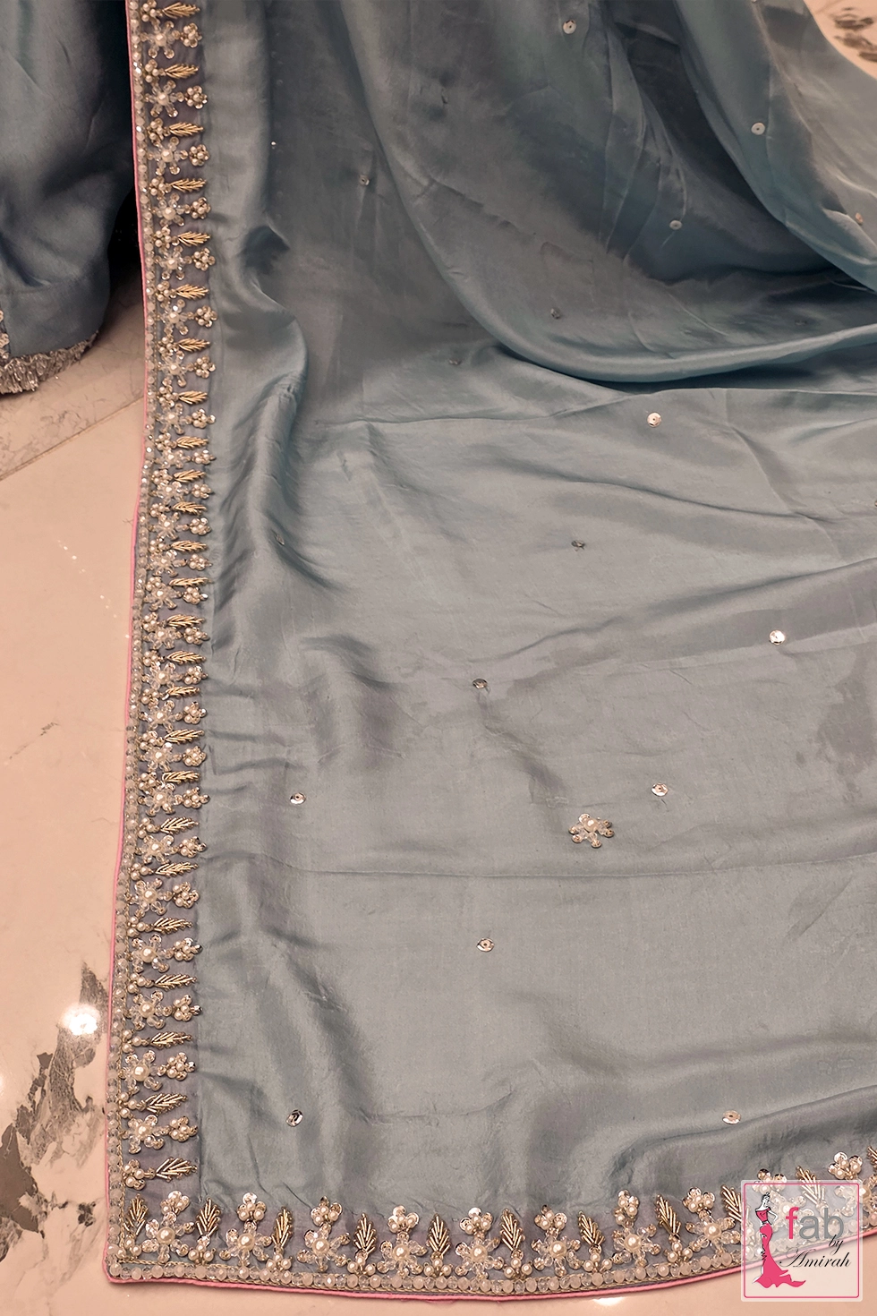Detail view of the dupatta border embellishment and sequin accents