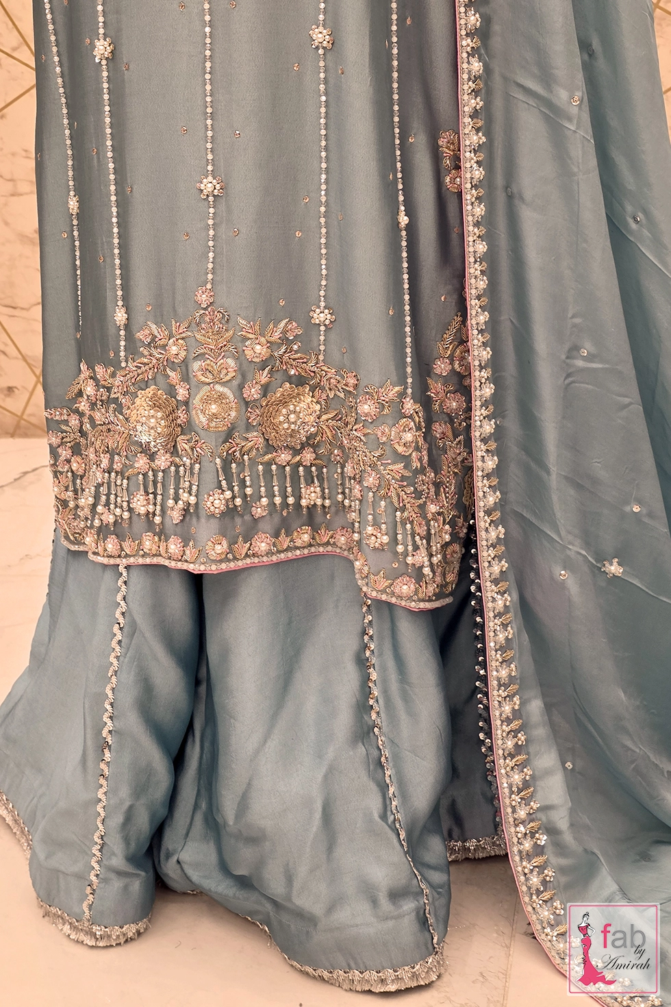 Close up of hemline embroidery and pearl fringe details