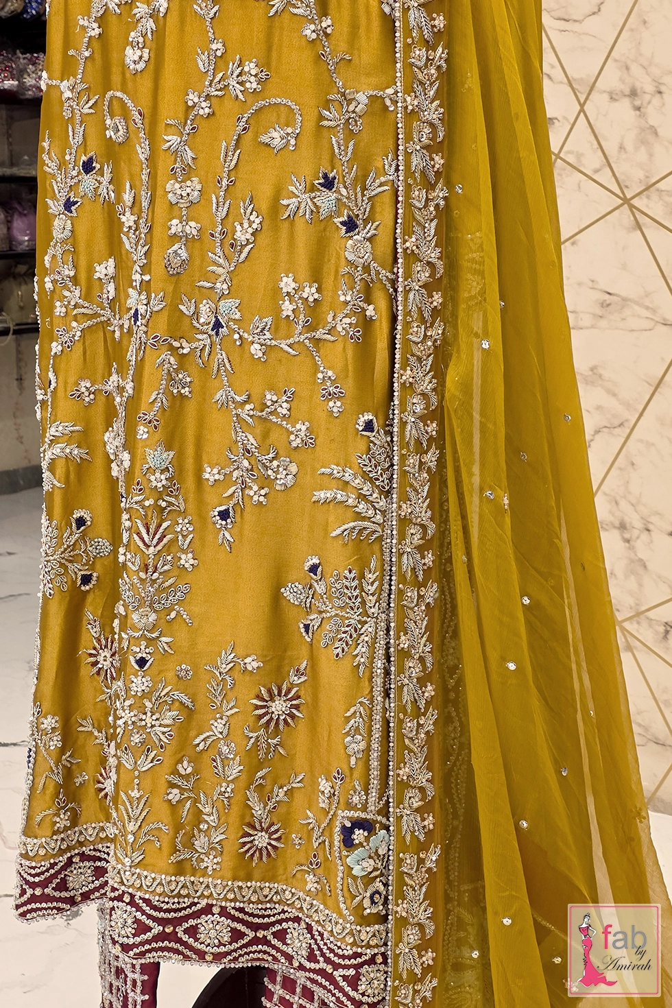 Close up view of floral vines and crystal embellishments on raw silk Close up view of floral vines and crystal embellishments on raw silk