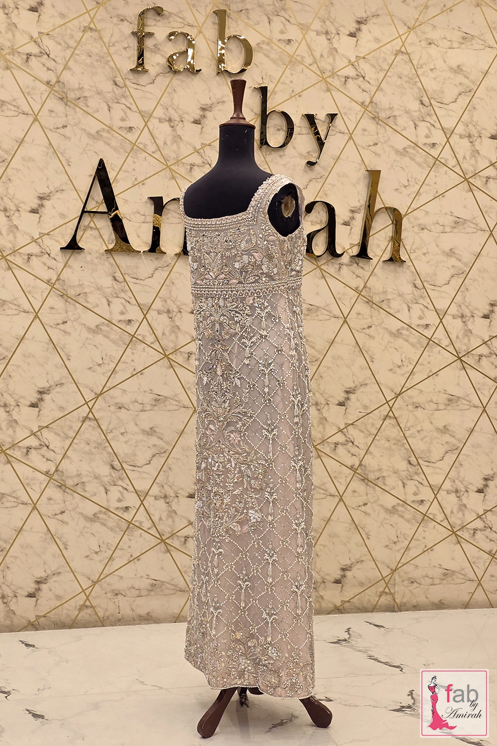 Side profile view of floor length taupe grey dress