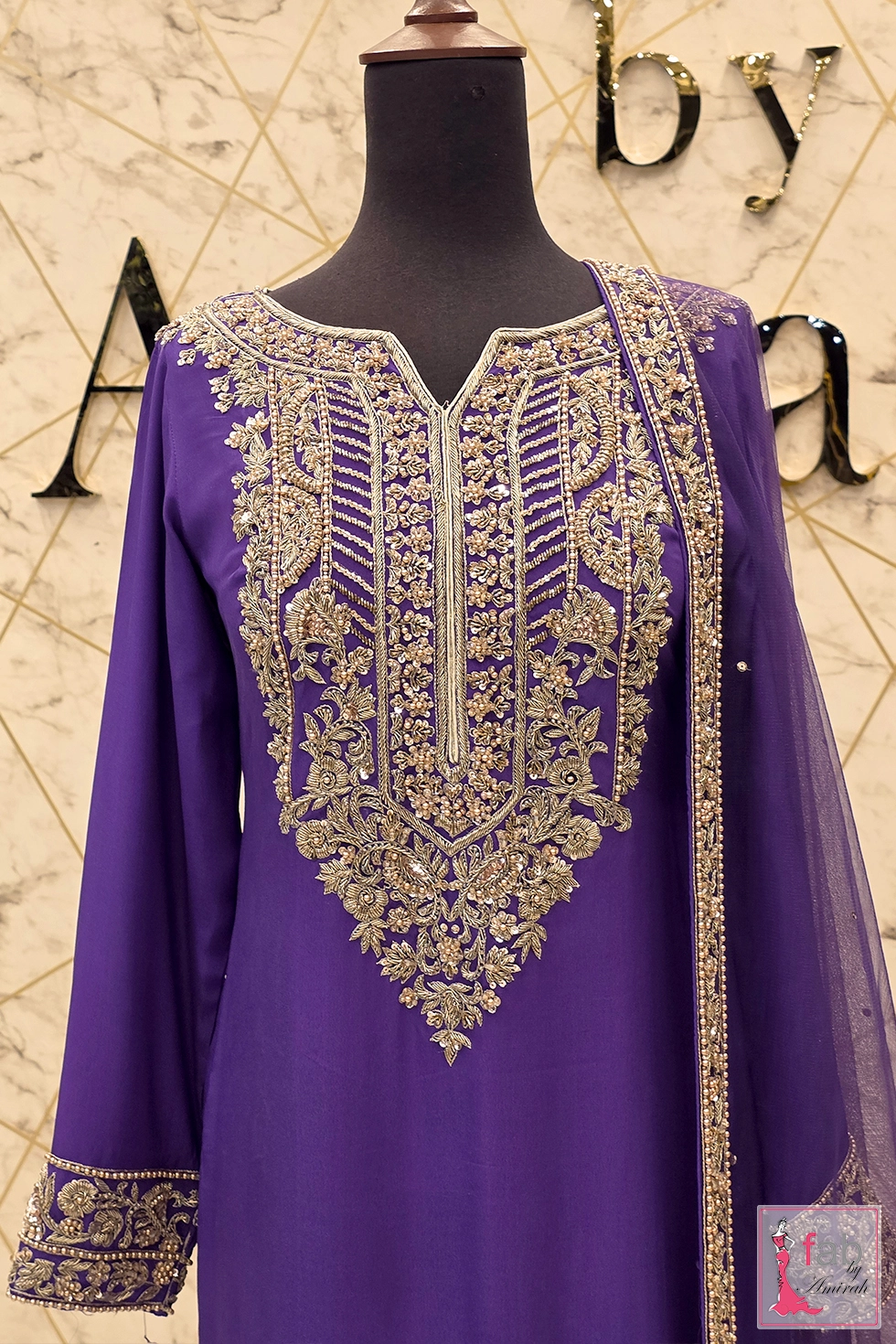 Upper torso shot of purple raw silk shirt with gold zardozi neck embellishment Upper torso shot of purple raw silk shirt with gold zardozi neck embellishment