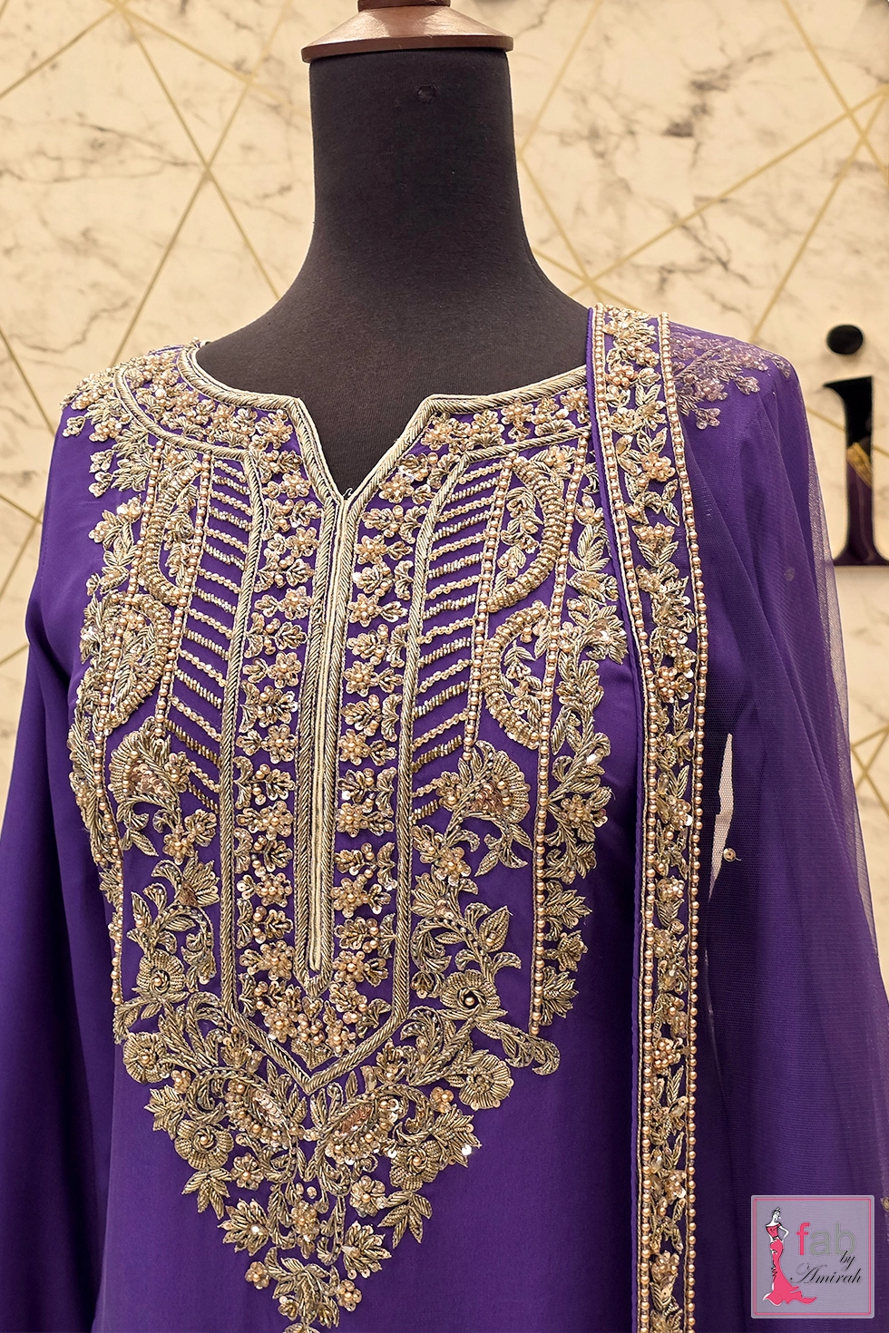 Close up view of detailed hand embroidered zardozi and pearl split neckline Close up view of detailed hand embroidered zardozi and pearl split neckline