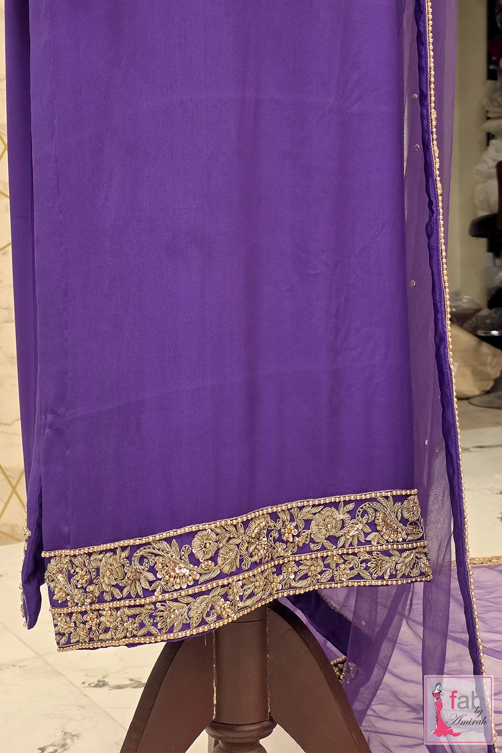 Detail shot of embroidered zardozi hemline and straight trouser border Detail shot of embroidered zardozi hemline and straight trouser border