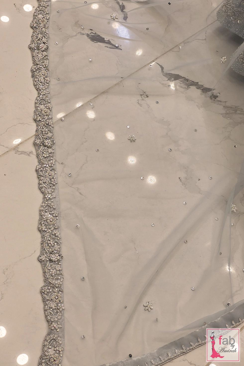 Detailed view of sheer net dupatta border with delicate silver hand embroidery