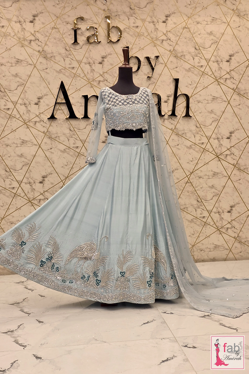 Wide angle display showing the full flare and spread of the ice blue lehenga skirt
